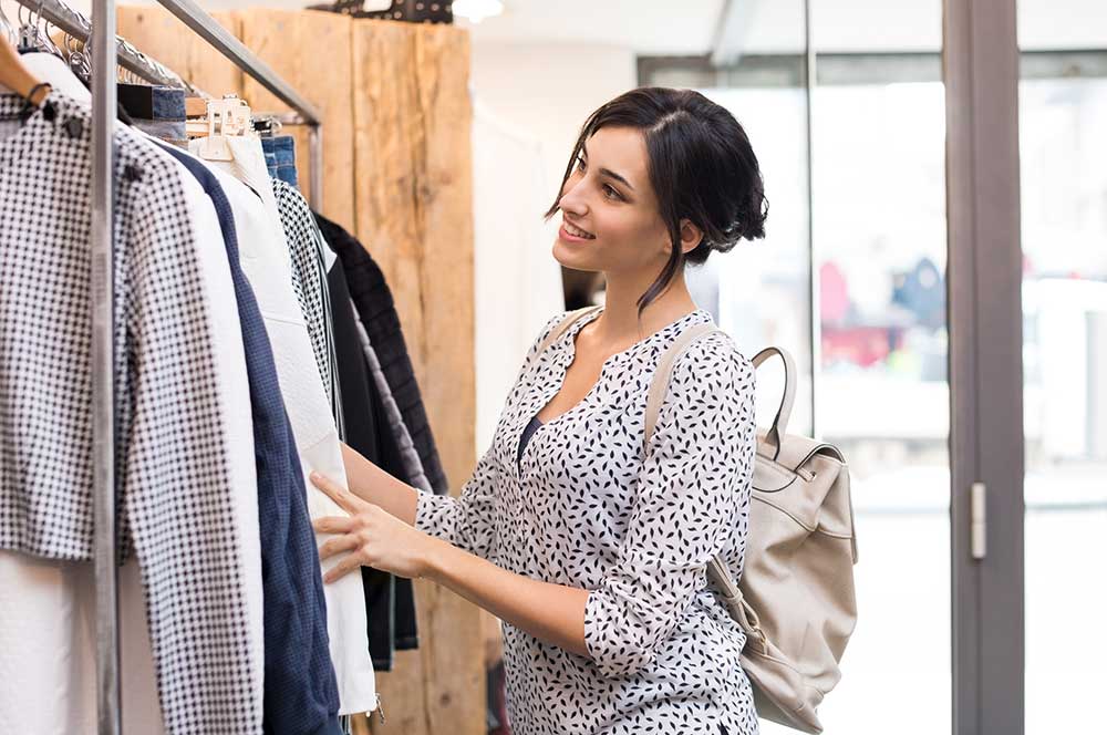 Woman looking at clothing at a shop
